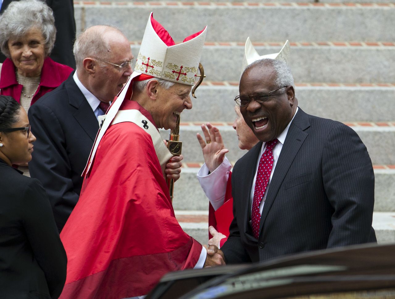 Cardinal Donald Wuerl, the archbishop of Washington, DC, shakes hands with Thomas in 2015.