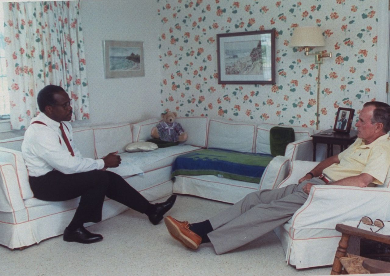 Thomas sits with US President George H.W. Bush at his vacation home in 1991. Bush nominated Thomas to fill the seat of retiring Supreme Court Justice Thurgood Marshall. At the time, Thomas was a judge for the US Court of Appeals for the District of Columbia Circuit.