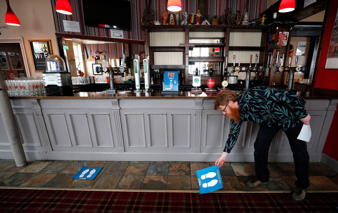 Social distancing markers are laid in front of the bar at the Chandos Arms pub in London.