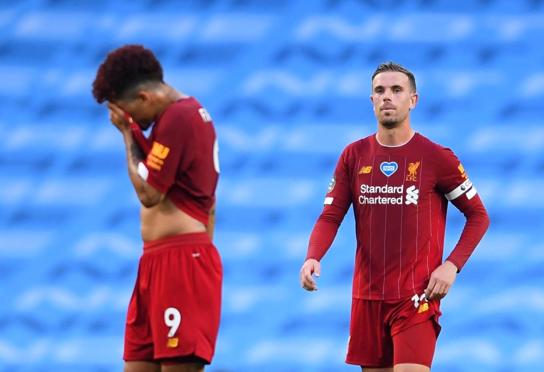 Roberto Firmino and Jordan Henderson look exasperated after Manchester City's third goal.