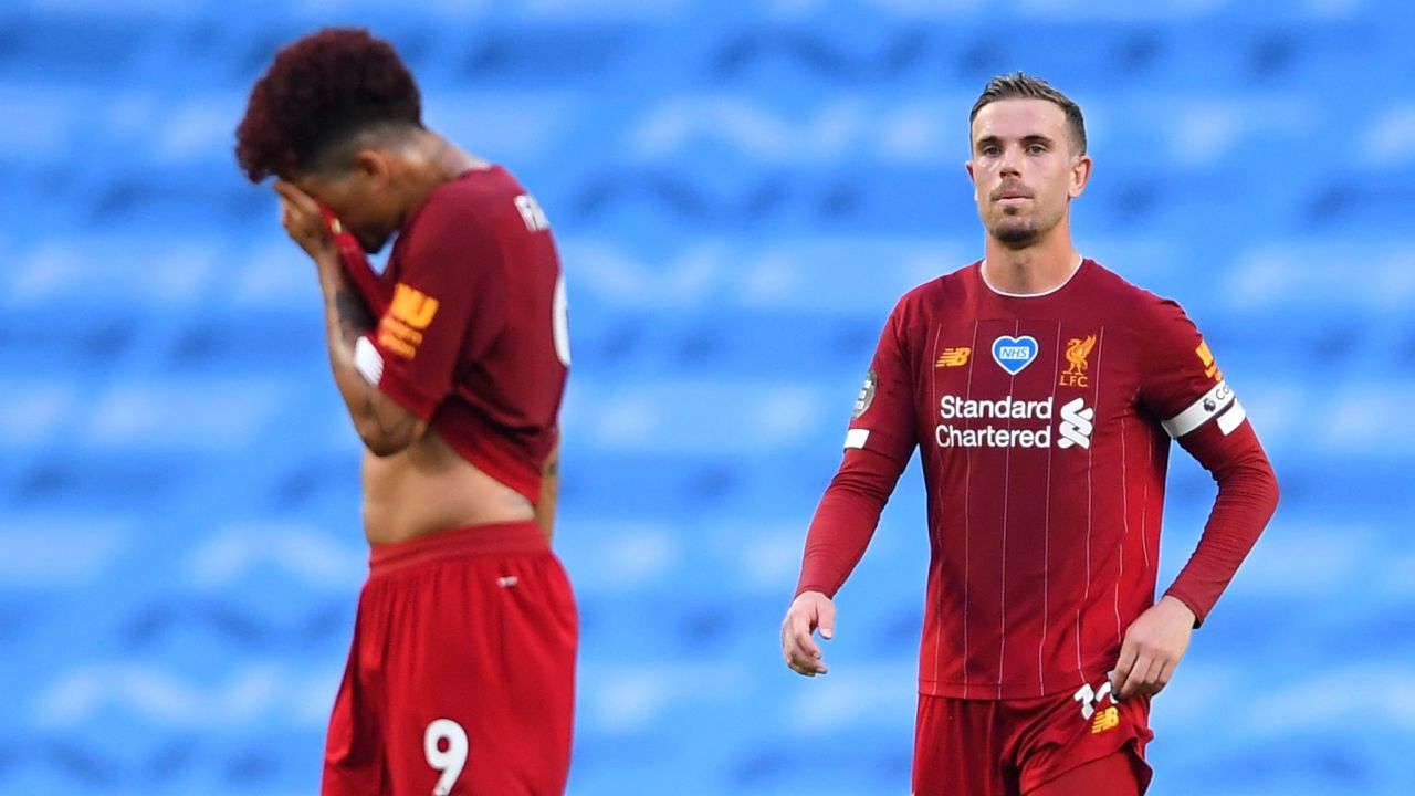 Roberto Firmino and Jordan Henderson look exasperated after Manchester City's third goal.