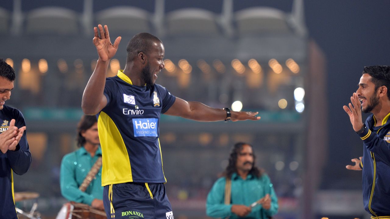 Sammy dances with teammates on a stage prior to the start of the final cricket match of the Pakistan Super League.