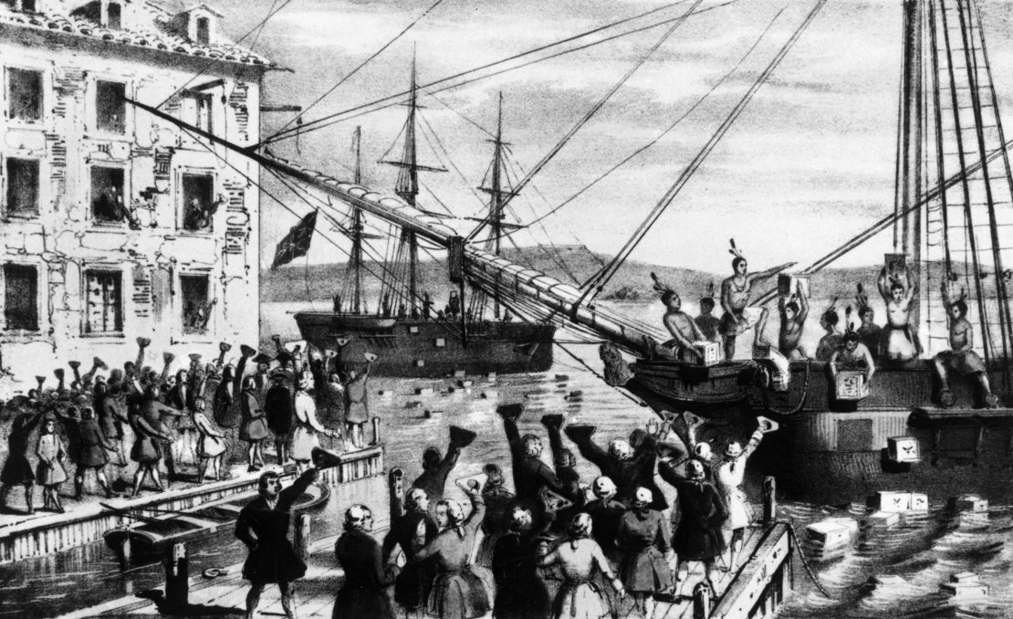 A group of Bostonians dressed as Native Americans dump crates of imported British tea into Boston Harbor as a protest against the British Tea Act in 1773.