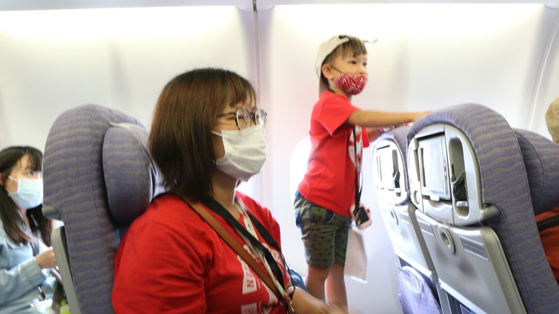 Travelers are issued a boarding pass and welcomed onto an airplane that never actually takes off.