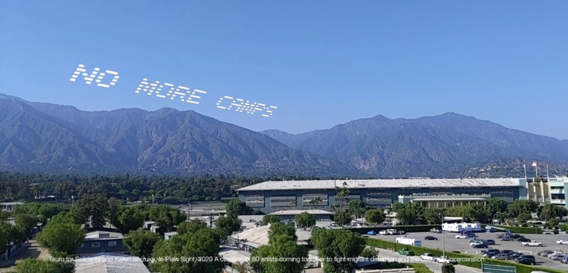 "NO MORE CAMPS" by curator Karen Ishizuka over the Santa Anita Assembly Center, California, captured in the "In Plain Sight " 4th Wall AR app.
