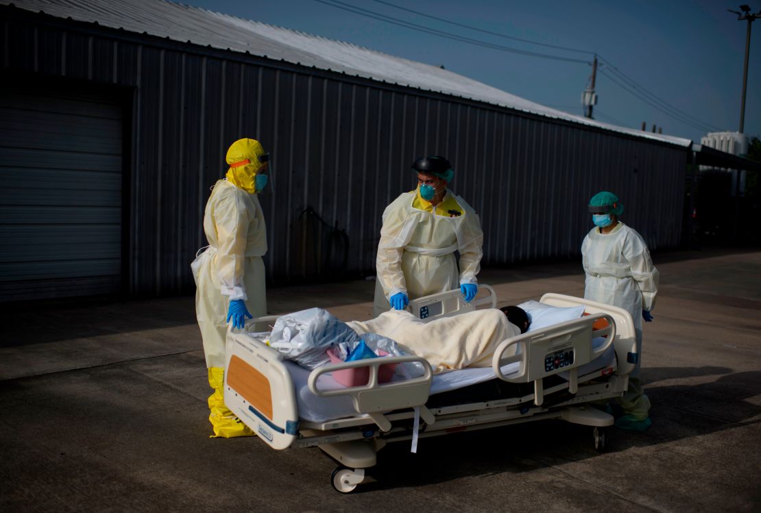 Health care workers push a patient from the Covid-19 unit at United Memorial Medical Center in Houston.