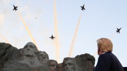 U.S. President Donald Trump looks at U.S. Navy Blue Angels aerial flypast as he and first lady Melania Trump attend South Dakota's U.S. Independence Day Mount Rushmore fireworks celebrations at Mt. Rushmore in Keystone, South Dakota, U.S., July 3, 2020. REUTERS/Tom Brenner