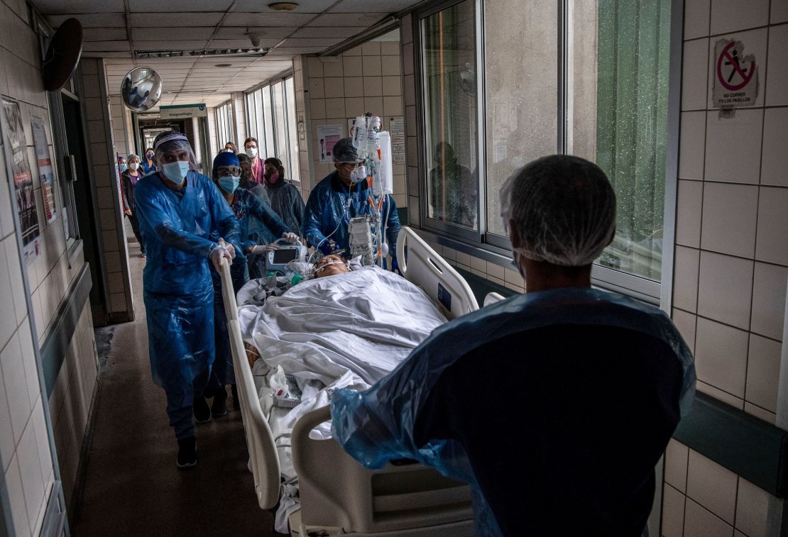 Nurses move a Covid-19 patient to a critical care unit at a hospital in Santiago, Chile, on June 24, 2020. 