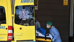 A medical worker is pictured lifting a patient out of an ambulance at a hospital in Lleida, northeastern Spain, on July 4, 2020. 