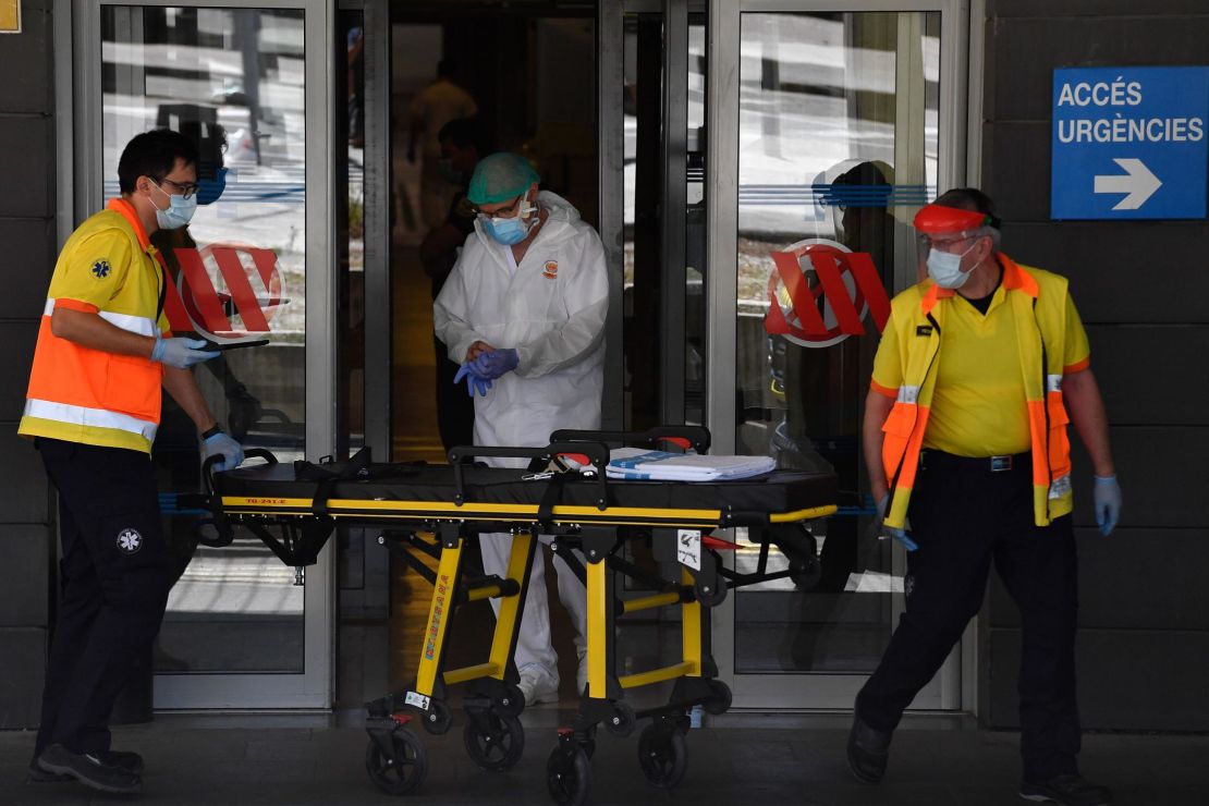 Paramedics push a stretcher outside a hospital in Lleida, northeastern Spain, on July 4, as 200,000 people in the area went into lockdown. 