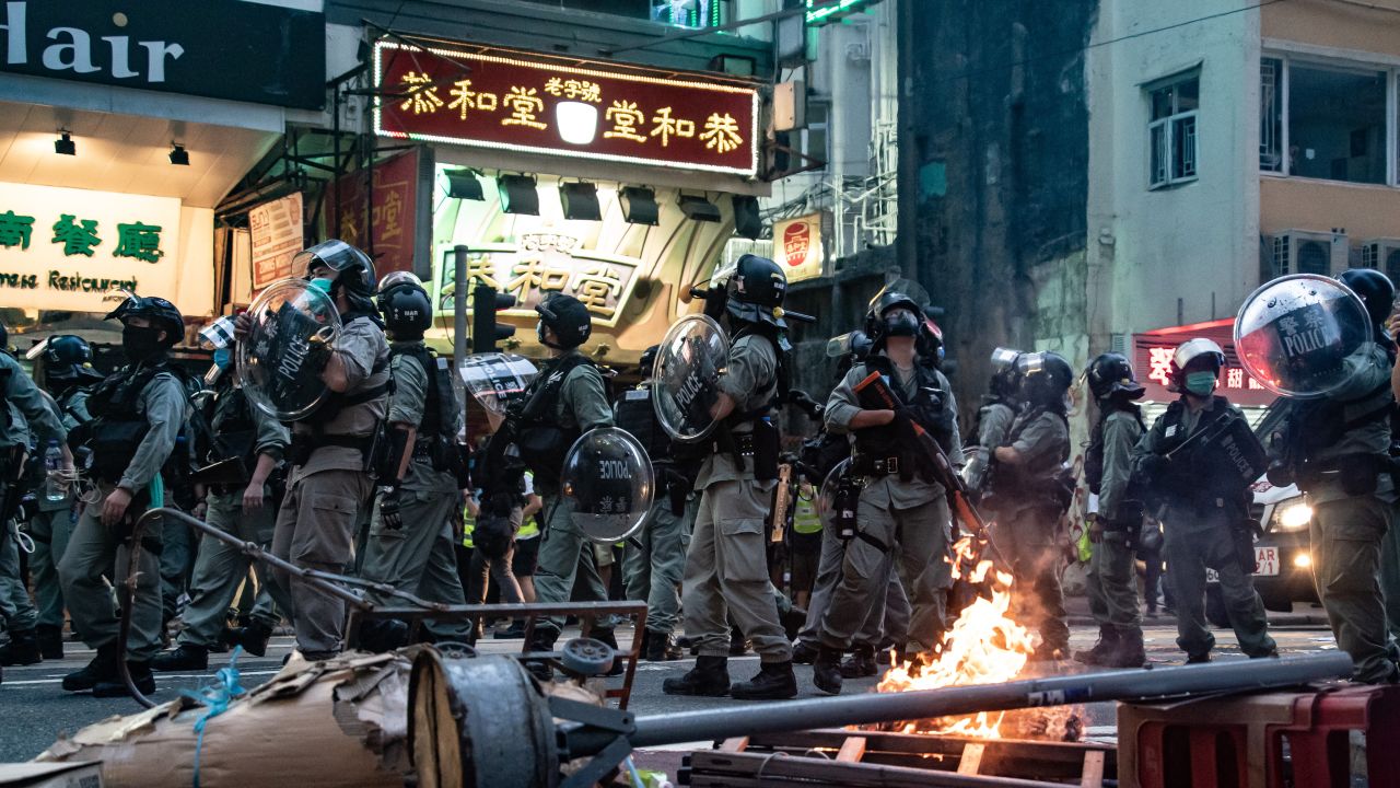 Riot police are seen in front of a burning road block during a protest against the new national security law on July 1, 2020, in Hong Kong.