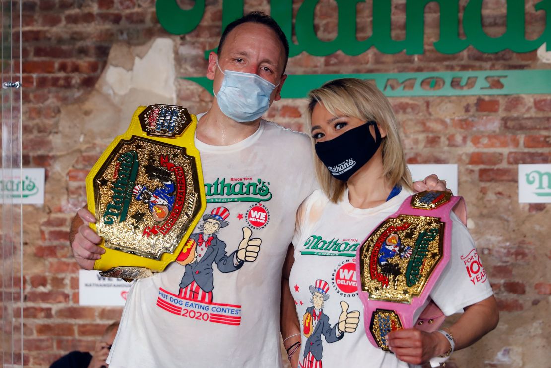 Competitive eaters Joey Chestnut and Miki Sudo after winning their respective divisions with new world records at the Nathan's Famous Hot Dog Eating Contest on Saturday.