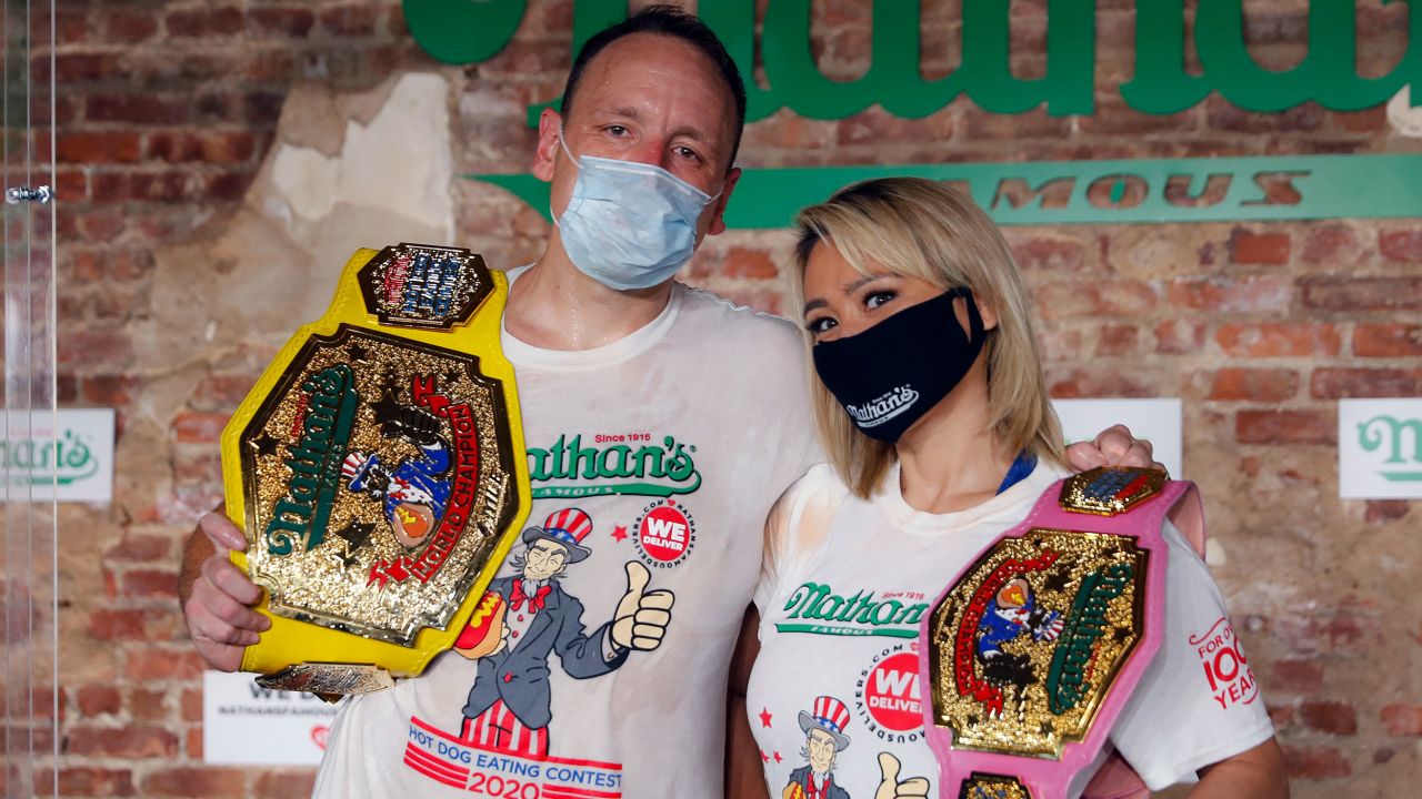 Competitive eaters Joey Chestnut and Miki Sudo after winning their respective divisions with new world records at the Nathan's Famous Hot Dog Eating Contest on Saturday.