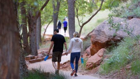 Hikers walking along a paved trail in Utah's Zion National Park, Utah, which had been closed due to the pandemic.