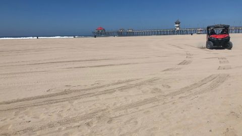 A normally crowded beach in Huntington Beach, California, is empty on July 4, 2020.