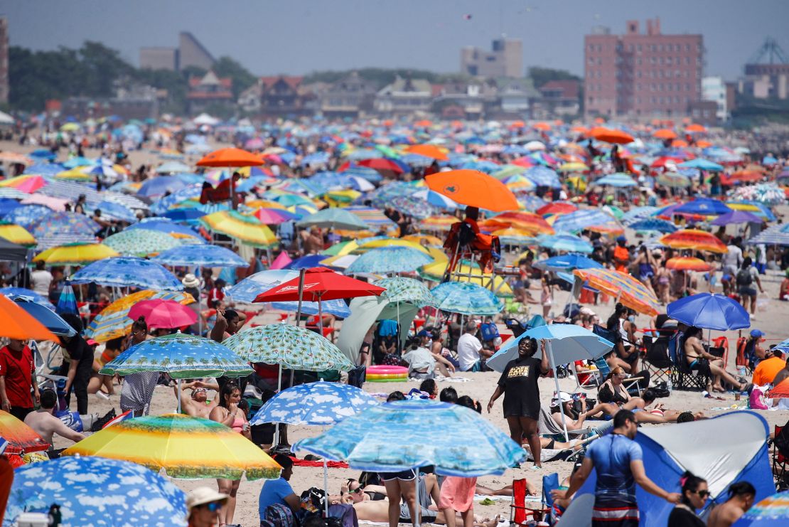 Revelers enjoy the beach at Coney Island in the Brooklyn borough of New York on Saturday, July 4, 2020.