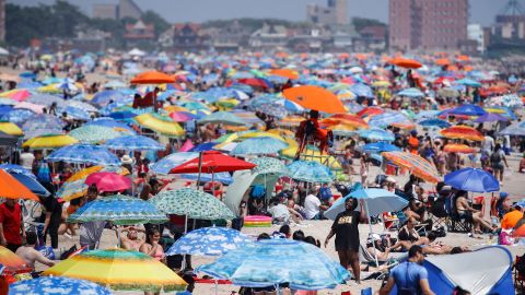 Revelers enjoy the beach at Coney Island in the Brooklyn borough of New York on Saturday, July 4, 2020.