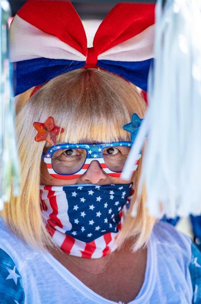 Christine Smith waits for the start of the Independence Day golf cart parade through Laguna Woods Village in Laguna Woods, California.