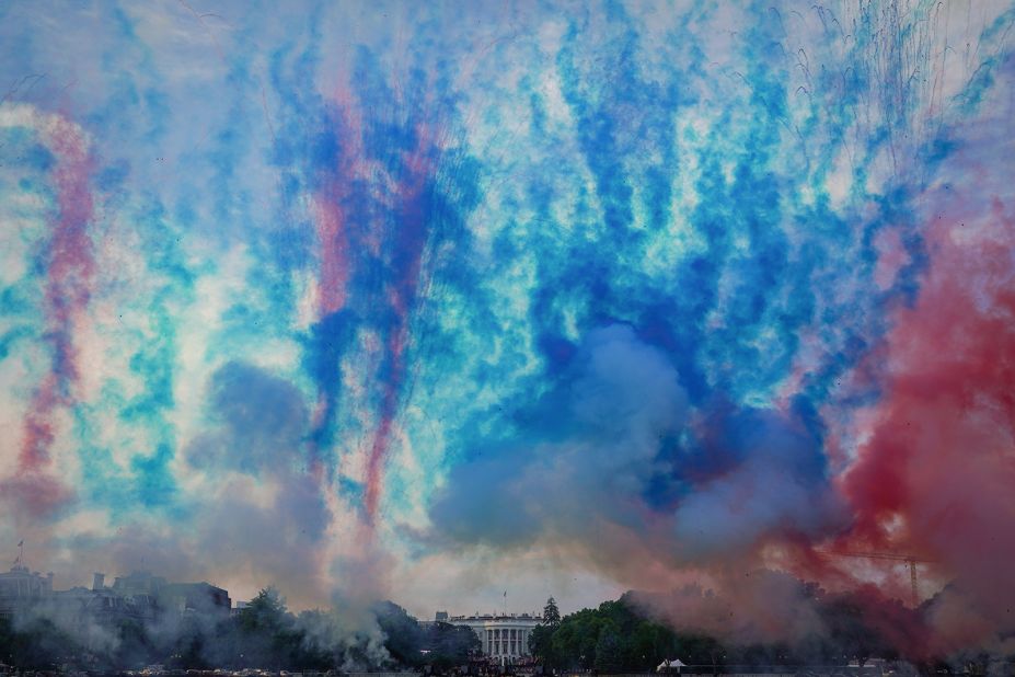 Red and blue smoke is fired during the "Salute to America" event near the White House in Washington DC. 