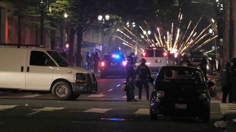 Police clear the streets after a riot was declared in Portland on Saturday.