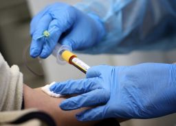 Residents have their blood drawn by a registered nurse for an antibody test for the coronavirus.