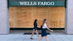 Women walk past the boarded up branch of a Wells Fargo bank ahead of demonstrations against the death of George Floyd by police officers in Minneapolis on June 1, 2020 in Washington, DC. Thousands of protesters took to the streets throughout the Washington to continue to show anger at Minneapolis Police officer Derek Chauvin who was filmed kneeling on George Floyd's neck before he was later pronounced dead at a local hospital. Floyd's death, the most recent in a series of deaths of African Americans while in police custody, has set off days and nights of protests across the country. (Photo by Joshua Roberts/Getty Images)