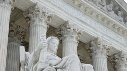 The statue Contemplation of Justice by sculptor James Earle Fraser stands on the steps of the U.S. Supreme Court.