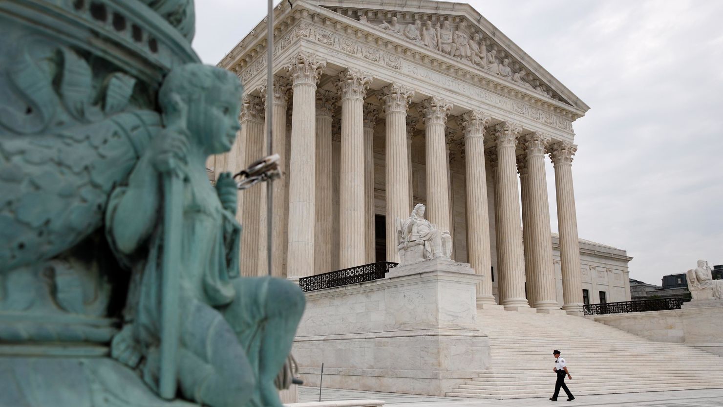 A police officer walks outside the Supreme Court on Capitol Hill in Washington, Monday, July 6, 2020.