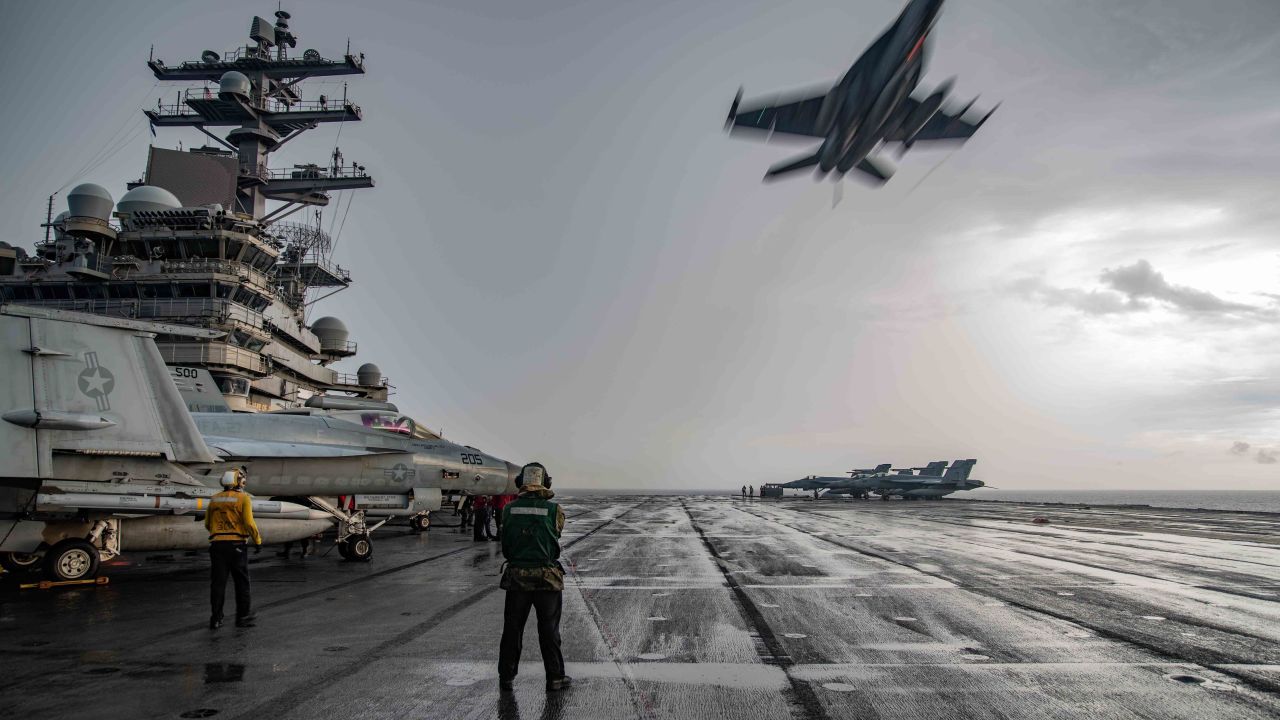 An F/A-18E Super Hornet flies over the flight deck of the carrier USS Ronald Reagan in the South China Sea last year.