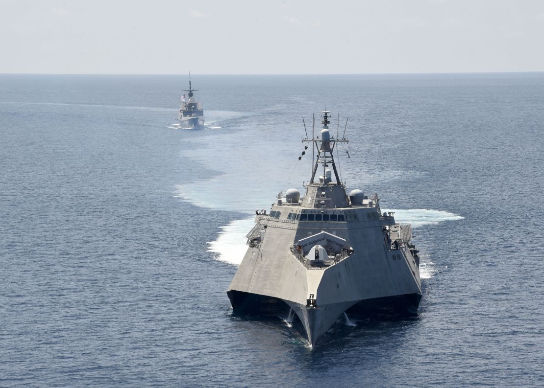 The Independence-variant littoral combat ship USS Gabrielle Giffords, front, takes part in exercises with the Singapore navy's Formidable-class multi-role stealth frigate RSS Steadfast in the South China Sea, May 25, 2020. 