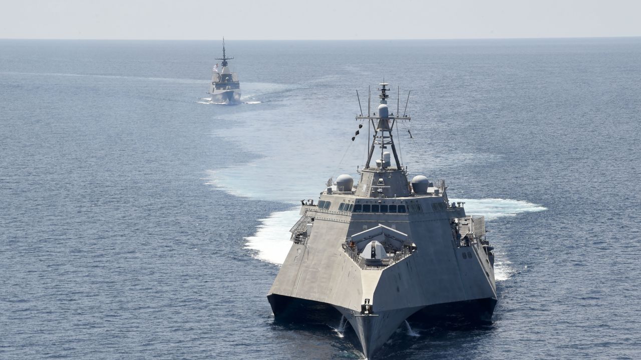 The Independence-variant littoral combat ship USS Gabrielle Giffords, front, takes part in exercises with the Singapore navy's Formidable-class multi-role stealth frigate RSS Steadfast in the South China Sea, May 25, 2020. 