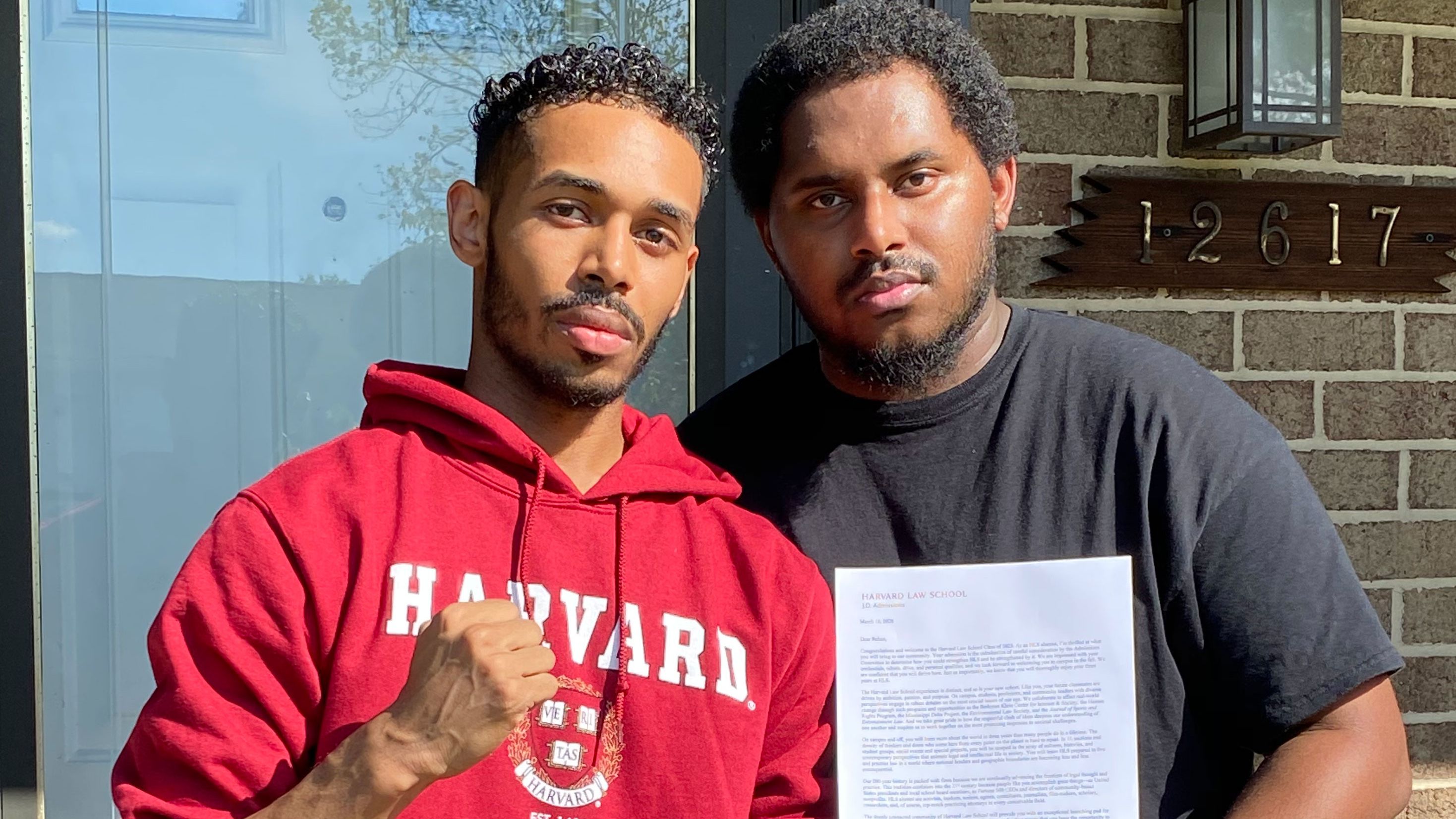 Rehan Staton, 24, with his brother Reggie Staton, 27, holding his acceptance letter to Harvard Law School. 