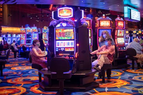 People play slot machines at the Ocean Casino in Atlantic City, New Jersey, on July 3. Atlantic City reopened eight of its nine casinos while limiting capacity to 25%.