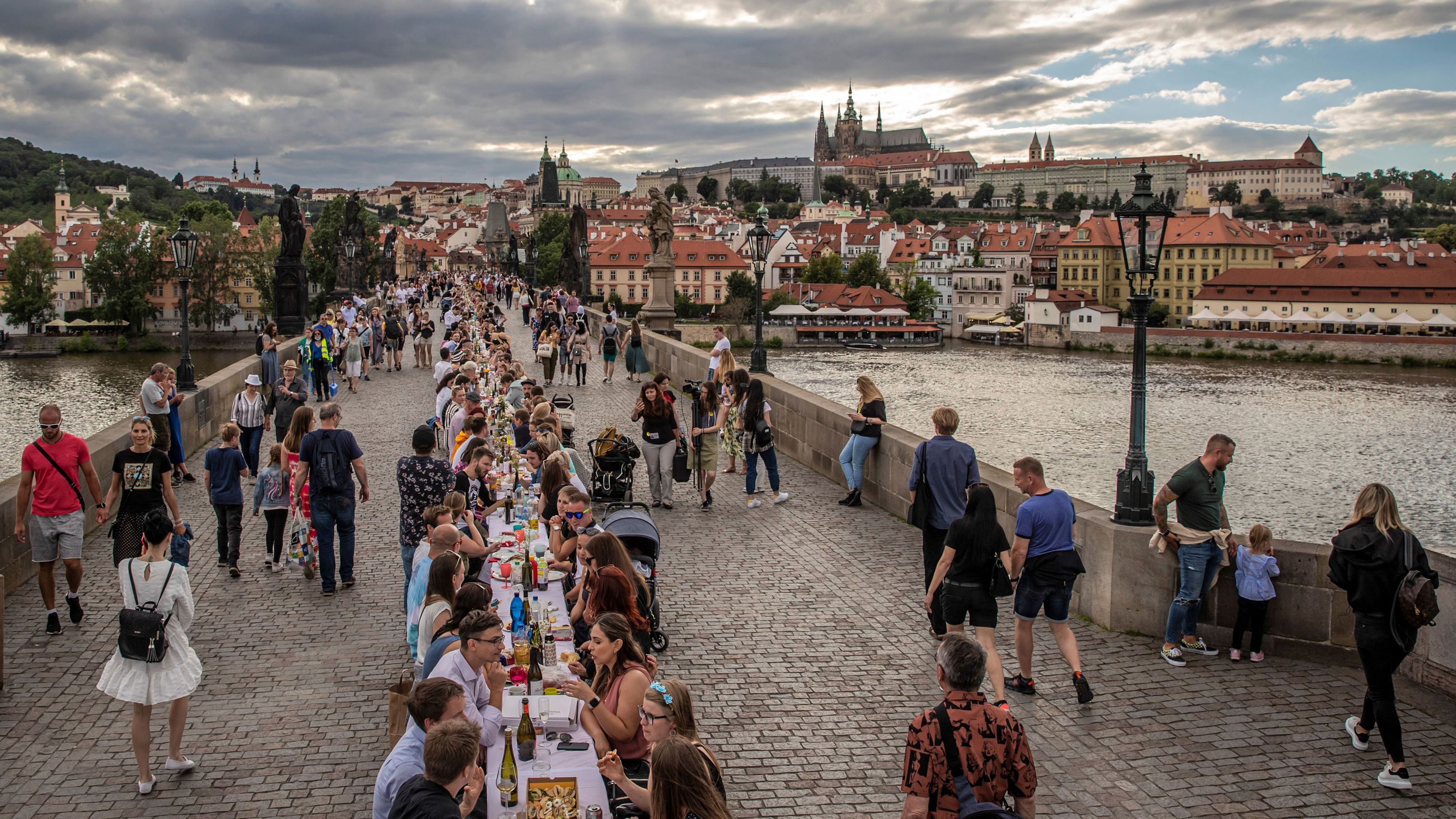 People sit at a giant table on the Charles Bridge in Prague, Czech Republic, on June 30. To celebrate the end of the country's lockdown, cafe owner Ondrej Kobza organized <a href="https://www.cnn.com/travel/article/czech-public-dinner-lockdown-scli-intl/index.html" target="_blank">the dinner party.</a> "We want to celebrate the end of the coronavirus crisis with people meeting up and showing they're no longer afraid to meet others. That they aren't afraid to accept a bite of a sandwich from someone," Kobza told the Agence France-Presse news agency. The Czech Republic was quick to implement a lockdown at the start of the outbreak and became one of the first countries to tell its citizens to wear masks. That helped it avoid the worst of the pandemic and ease restrictions earlier than many other nations.