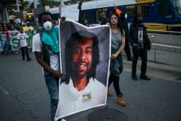 Protesters cary a photo of Philando Castile, who was killed by police in Minnesota after he was pulled over for a broken taillight.