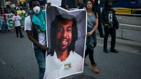 Protesters cary a photo of Philando Castile, who was killed by police in Minnesota after he was pulled over for a broken taillight. 