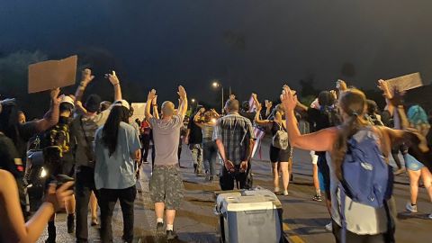 Protesters walk along Encanto Boulevard on July 5 after Phoenix police shot and killed a man the previous day.