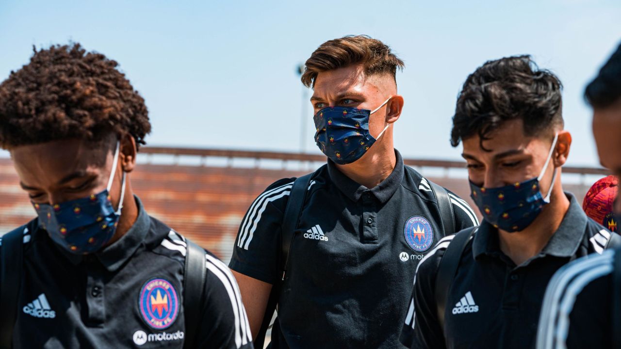 Members of Chicago Fire FC don masks on the way to training.