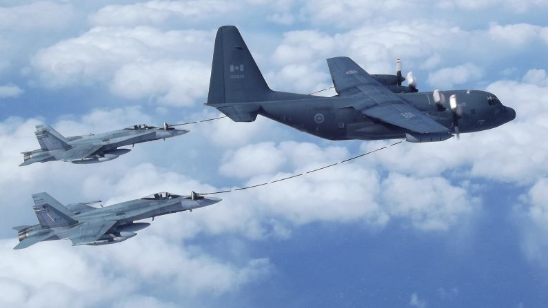 <strong>Aerial refueling:</strong> Refueling in mid-air -- as with these two Royal Canadian Air Force CF-18 Hornets -- is standard procedure in military aviation. 