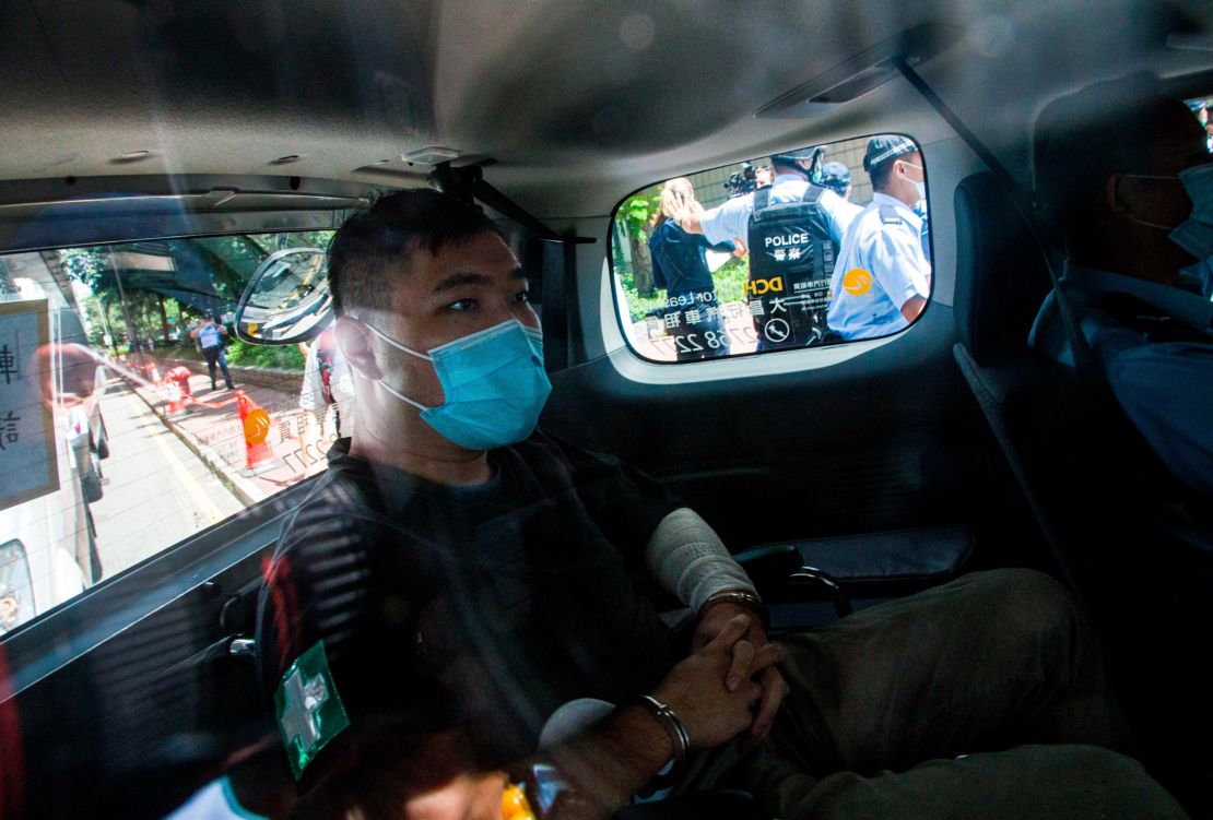 Hong Kong defendant Tong Ying-Kit arrives at court after being accused of deliberately driving his motorcycle into a group of police officers.