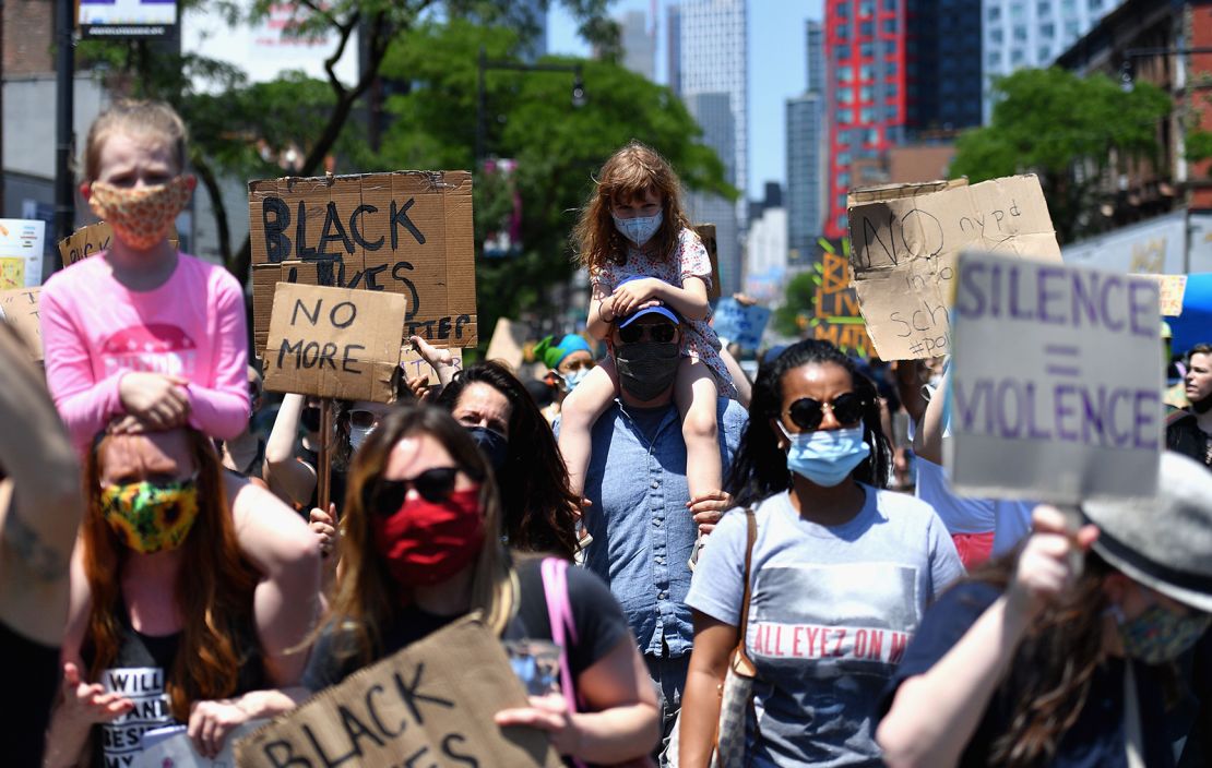 Families participate in a children's march in solidarity with the Black Lives Matter movement and national protests against police brutality June 9, 2020, in Brooklyn, New York.