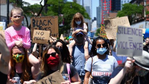 Families participate in a children's march in solidarity with the Black Lives Matter movement and national protests against police brutality in Brooklyn, New York.