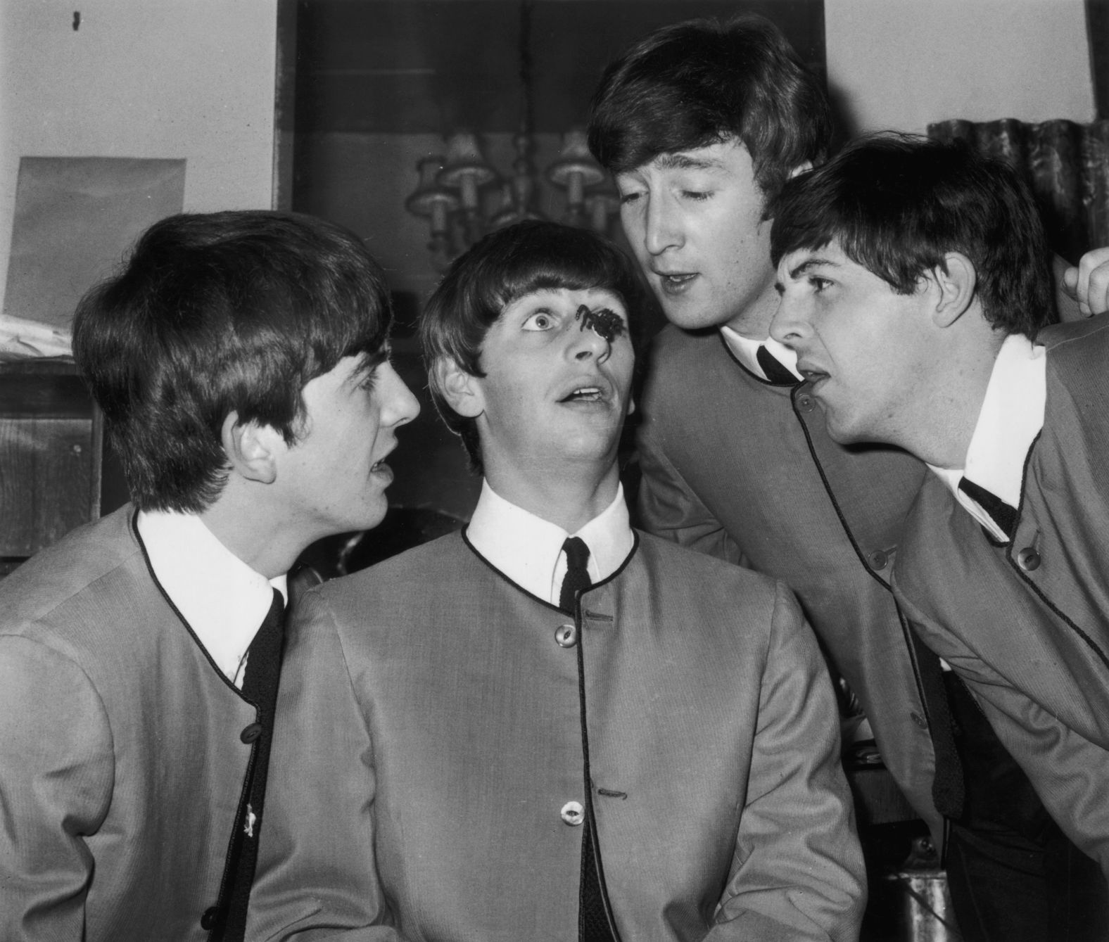 The Beatles stare at a plastic spider on Starr's nose in October 1963. With Starr, from left, are George Harrison, John Lennon and Paul McCartney.