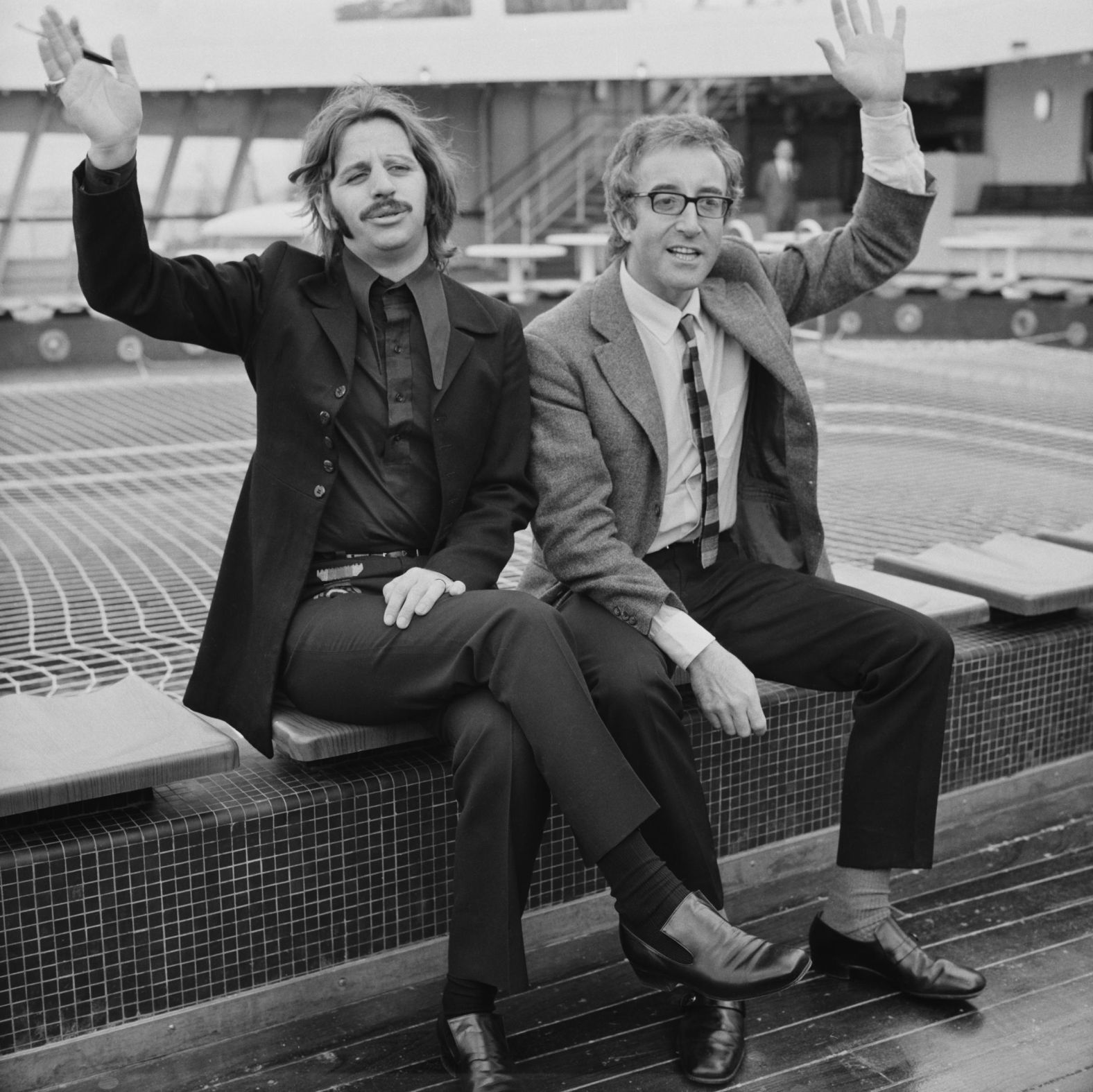 Starr and film actor Peter Sellers wave from a cruise ship before sailing for America in 1969. The two starred in the 1969 film "The Magic Christian."