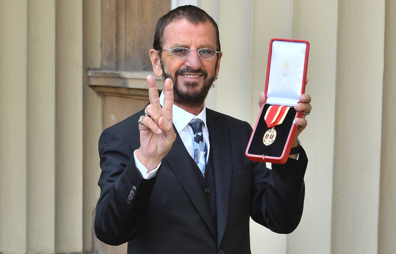 Starr poses with his medal after being awarded a knighthood by Queen Elizabeth II in 2018.