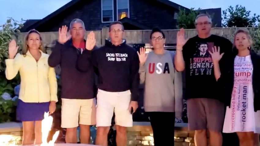 Former national security adviser Michael Flynn (third from left) and members of his family recite an oath that is affiliated with the QAnon conspiracy movement. The image comes from a video Flynn posted to his Twitter feed on July 4, 2020.