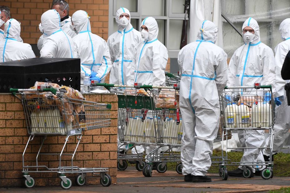 Firefighters dressed in personal protective equipment prepare to distribute food at a public housing tower in North Melbourne, Australia, on July 7. Metropolitan Melbourne was placed under lockdown amid a <a href="https://www.cnn.com/2020/07/07/asia/melbourne-coronavirus-lockdown-intl-hnk/index.html" target="_blank">resurgence of coronavirus cases.</a>