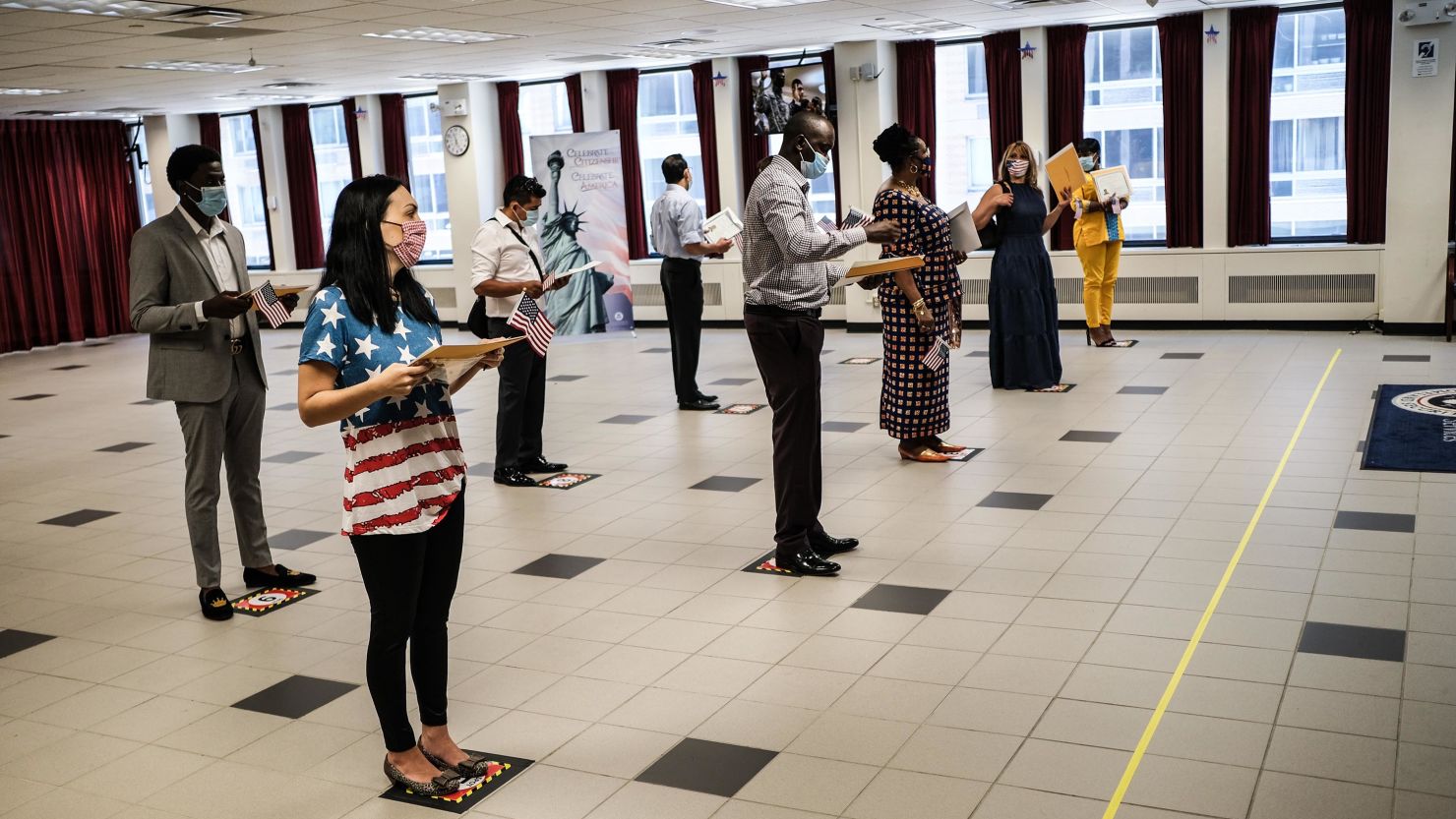 People are sworn in as new American citizens during a ceremony at the U.S. Citizenship and Immigration Services New York Field Office on July 2, 2020 in New York City. The ceremonies were brief and observed precautions, like wearing a mask and adhering to social distancing, to limit exposure to the coronavirus for those in attendance.