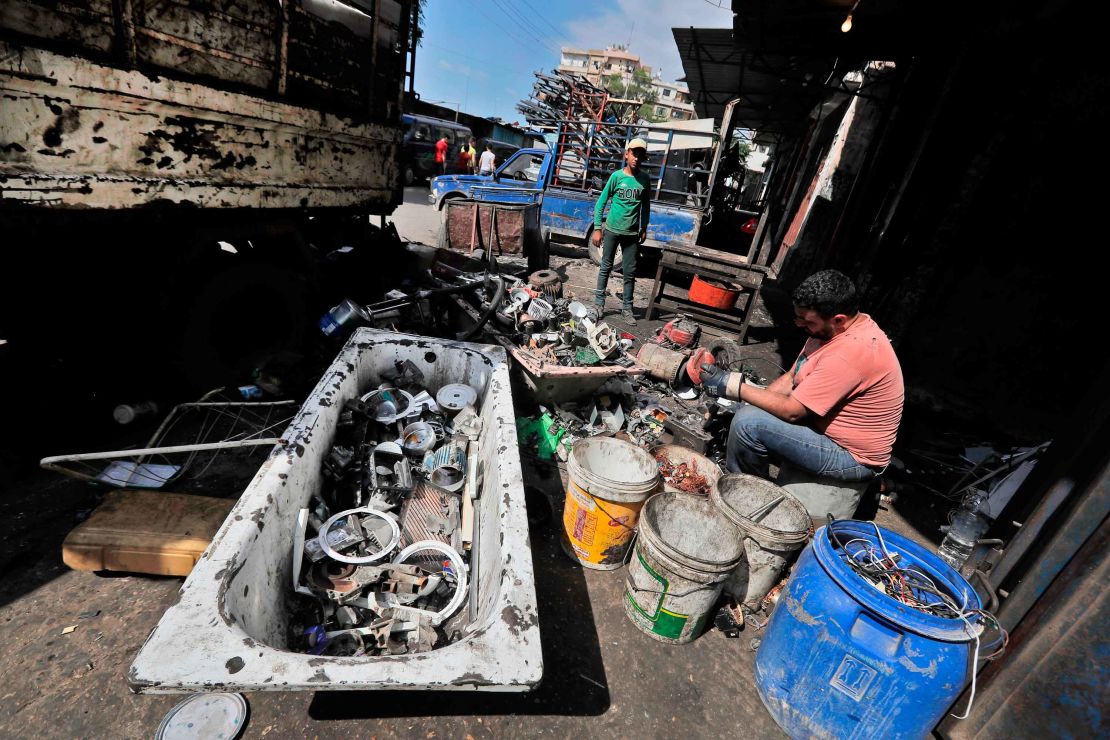 A man dismantles and sorts through discarded electric devices at a scrap workshop in the Bab al-Tabbaneh neighborhood of Lebanon's northern city of Tripoli on June 3, 2020. 