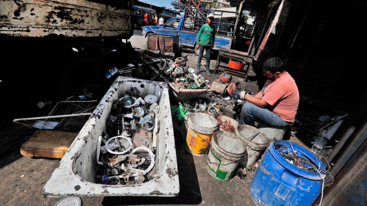 A man dismantles and sorts through discarded electric devices at a scrap workshop in the Bab al-Tabbaneh neighborhood of Lebanon's northern city of Tripoli on June 3, 2020.